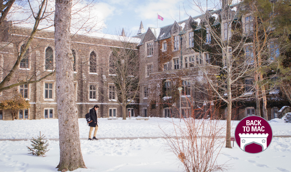 winter scene on McMaster campus. person walking through campus grounds